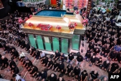 Shi'a Muslim devotees pray while attending a mourning ritual at the Karbala Mosque in Tehran on June 25 at the peak of Ashura, a 10-day period commemorating the seventh-century killing of Prophet Muhammad's grandson Imam Hussein.