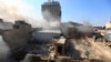 Smoke rises from the site of a bomb attack near Khullani Square in Baghdad on February 5, a day on which dozens died in explosions in the Iraqi capital. 