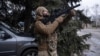 A Ukrainian soldier monitors the sky for Russian drones during an evacuation of an injured service member in the Donetsk region in February. 