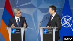 Belgium -- NATO Secretary-General Anders Fogh Rasmussen (R) and Armenian President Serzh Sarkisian speak at a news conference at NATO headquarters in Brussels, 06Mar2012