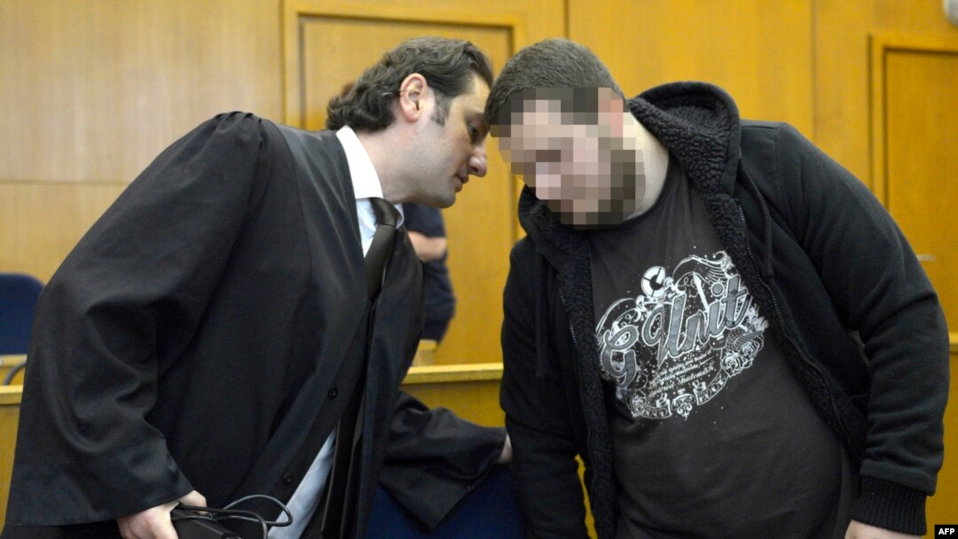 Kreshnik Berisha (right) listens to his lawyer as he arrives at court in Frankfurt in September.