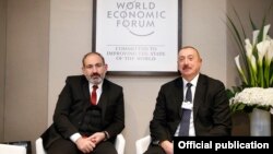 Switzerland - Armenian Prime Minister Nikol Pashinian (L) and Azerbaijan's President Ilham Aliyev meet in Davos, January 22, 2019.