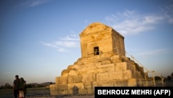 An Iranian family poses for a picture on May 19, 2015, next to the tomb of Cyrus the Great of Persia.