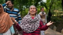 A woman reacts after her house was damaged by Pakistani artillery shelling in Uri, a village north of Srinagar in Indian-controlled Kashmir