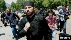 Orthodox clergy and Orthodox Christian activists clashed with gay-rights activists at a rally in Tbilisi marking International Day Against Homophobia on May 17.