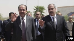 Prime Minister Nuri al-Maliki (left) tours the Kurdish city of Halabja.