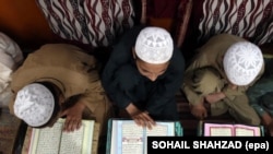 Students study the Koran at a religious school run by a religious scholar and leader of the political party Jamiat Ulam-e Islam at Akora Khattak.