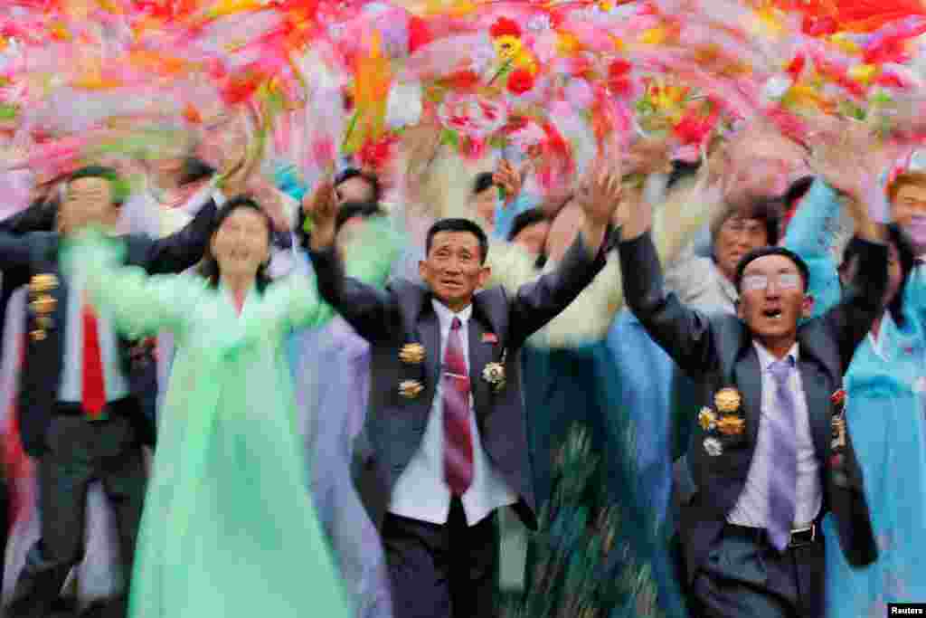 People react as they see North Korean leader Kim Jong Un during a mass rally and parade in the main ceremonial square in Pyongyang, a day after the ruling party wrapped up its first congress in 36 years by elevating him to party chairman. (Reuters/Damir Sagolj)