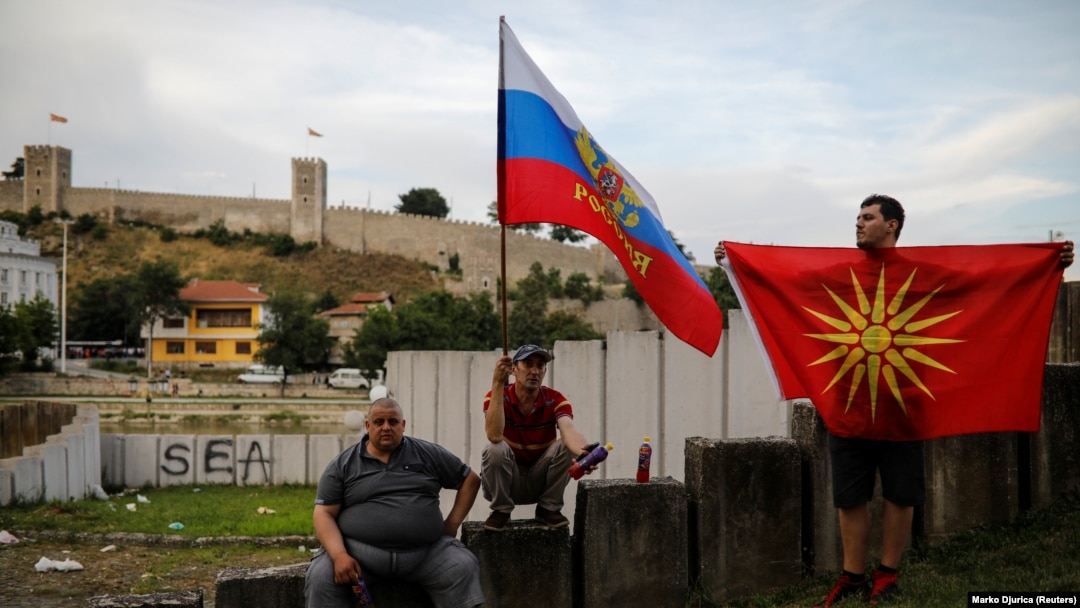 Supporters of opposition party VMRO-DPMNE hold Russian and Macedonian flags as they take part in a protest over the compromise solution in Macedonia's dispute with Greece over the country's name in Skopje last month.
