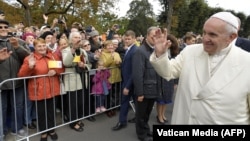 Pope Francis greets well-wishers as he arrives at the Monument of Freedom in Riga on September 24.