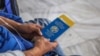Аэропортто паспортун жана билетин кармап отурган кыргызстандык жаран. Иллюстрациялык сүрөт.