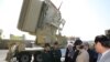 Iranian President Hassan Rohani (3rd L) and Iranian Defense Minister Hossein Dehghan (2nd L) stand in front of the new air defense missile system Bavar-373, in Tehran, August 21, 2016