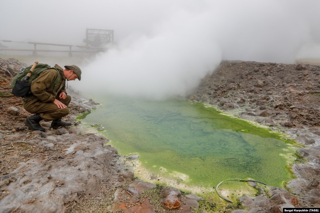 A member of the expedition checks out a sulphur spring. As well as hunting for antique military leftovers, the team is also tasked with various &ldquo;botanical, volcanological, and geological&rdquo; studies.