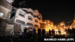 Palestinians inspect the damaged house of Islamic Jihad leader Baha Abu Al-Ata after an Israeli attack in Gaza city, on November 12, 2019. 