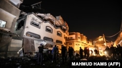 Palestinians inspect the damaged house of Islamic Jihad leader Baha Abu Al-Ata after an Israeli attack in Gaza city, on November 12, 2019. 