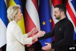 Ukrainian President Volodymyr Zelenskyy (right) greets European Commission President Ursula von der Leyen at a meeting in Kyiv on February 24.