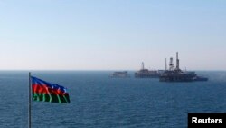 Azerbaijan -- A state flag flutters in the wind on an oil platform in the Caspian Sea, 22Jan2013