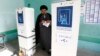 Shi'ite cleric Muqtada al-Sadr casts his vote at a polling station in Baghdad during parliamentary elections on April 30.