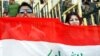 Fans of Iraq's national soccer team hold up the Iraqi flag in Irbil, the capital of the autonomous Kurdish region.