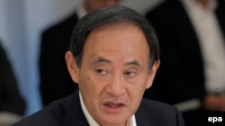 Szuga Josihide 2013-ban, kabinetfőnökként.
