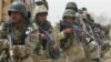  Iraqi soldiers take combat position during a search for insurgents south of Ba'qubah.