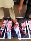 Противники тогдашнего сирийского диктатора Башара Асада попирают ногами плакаты с изображением Асада, аятоллы Хаменеи и Владимира Путина (фото 2018 года) 