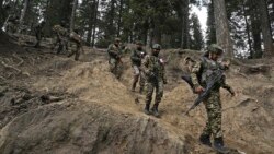 Indian soldiers trek back after a search operation in the day after an attack in Pahalgamthat killed 26 civilians.