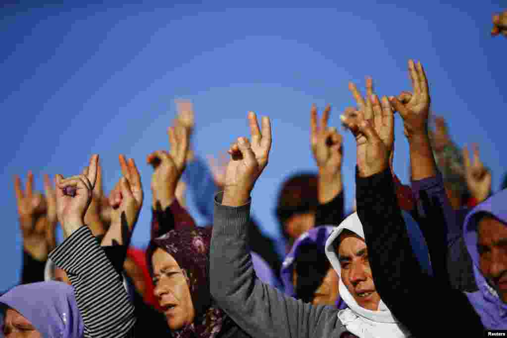 Turkish Kurdish women show the victory sign during the funeral of Kurdish fighters killed during clashes against Islamic State in Kobani, at a cemetery in the southeastern town of Suruc, Sanliurfa province on October 21. (Reuters/Kai Pfaffenbach)