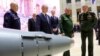 RUSSIA -- Russian President Vladimir Putin (C), Defense Minister Sergei Shoigu, and Chief of the General Staff Valery Gerasimov visit an exhibition at the Russian military's headquarters as part of a conference on the Russian campaign in Syria in Moscow, 