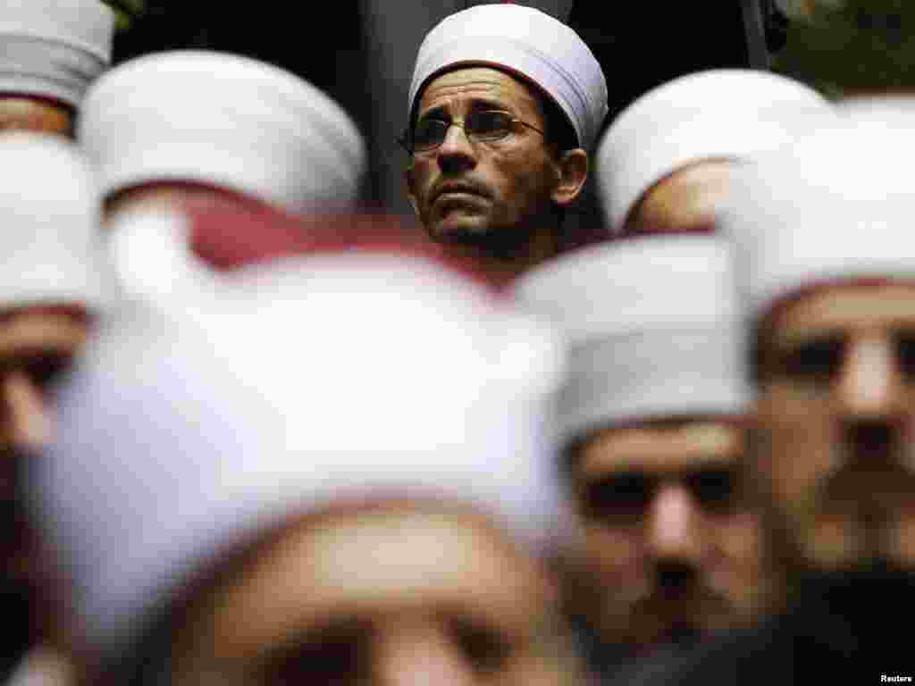 Bosnian muslim clerics gather to pray after climbing up a mountain during the Ajvatovica ceremony in Prusac on June 27. Tens of thousands of Muslims participate in the trek, the largest Muslim pilgrimage in Europe. Photo by Dado Ruvic for Reuters