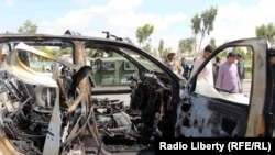 FILE: The aftermath of a roadside bomb attack in Kandahar city in April 2018.