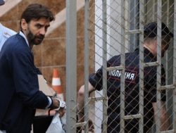 Mikhail Abyzov is escorted to a court in Moscow in May 2019.