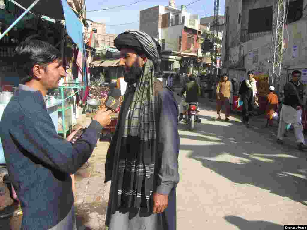 Radio Mashaal correspondent Umar Daraz Wazir, conducting an interview in Bannu, Pakistan. October 2014