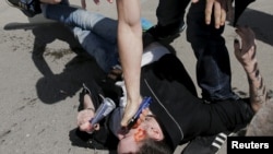 An antigay protester uses pepper spray against gay-rights activists during an LGBT rally in central Moscow in May.