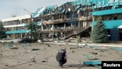 An inspector surveys the damage at a grain port facility after an attack by Russian military drones in Izmayil, in Ukraine's Odesa region, on August 2.