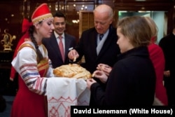 Then-U.S. Vice President Joe Biden, his wife, Jill, and his granddaughter Finnegan participate in a bread-and-salt welcoming ceremony in Moscow on March 8, 2011.