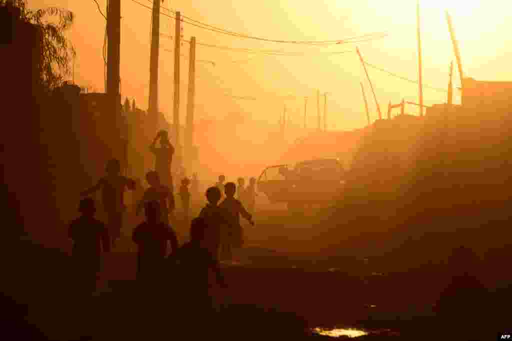 Afghan children play during sunset in Zaranj in the southwestern province of Nimroz. (AFP/Aref Karimi)