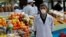 KAZAKHSTAN -- A vendor wearing a protective face mask following an outbreak of the coronavirus disease (COVID-19) waits for customers at a local food market, also known as bazaar, in Almaty, March 20, 2020