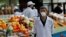KAZAKHSTAN -- A vendor wearing a protective face mask following an outbreak of the coronavirus disease (COVID-19) waits for customers at a local food market, also known as bazaar, in Almaty, March 20, 2020