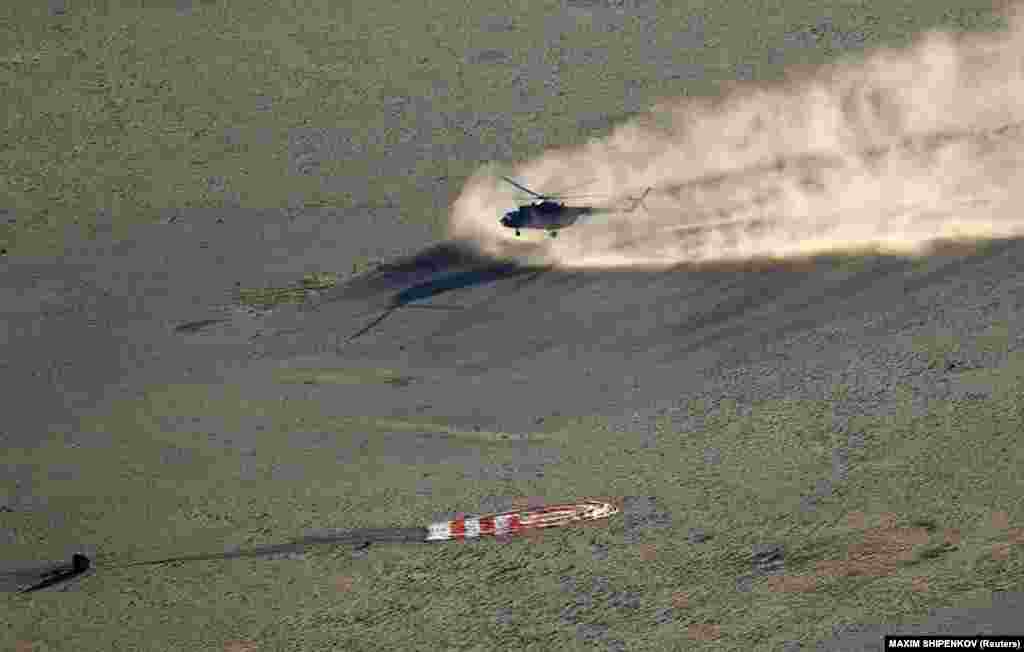 A search-and-rescue helicopter lands next to the Soyuz MS-08 capsule carrying astronauts Drew Feustel and Ricky Arnold of the United States and cosmonaut Oleg Artemyev of Russia after landing in a remote area of Kazakhstan on October 4. The three spent six months aboard the International Space Station. (Reuters/Maxim Shipenkov)