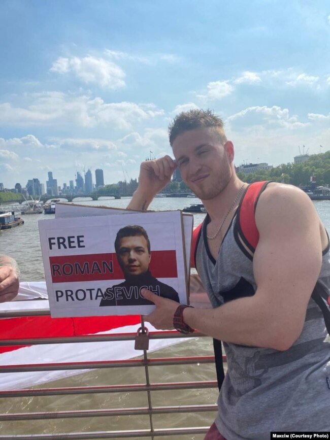 Maksim photographed in London, holding a sign in support of dissident Belarusian blogger Raman Pratasevich, who was dragged off an Athens-to-Vilnius flight that was diverted to Minsk on May 23 and arrested along with his Russian girlfriend, Sofia Sapaga.