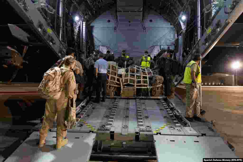 Spanish troops prepare to depart for Afghanistan at the Zaragoza air base, northeastern Spain, in the early morning of 17 August. The troops will evacuate Spanish nationals and local Afghans who worked for them.