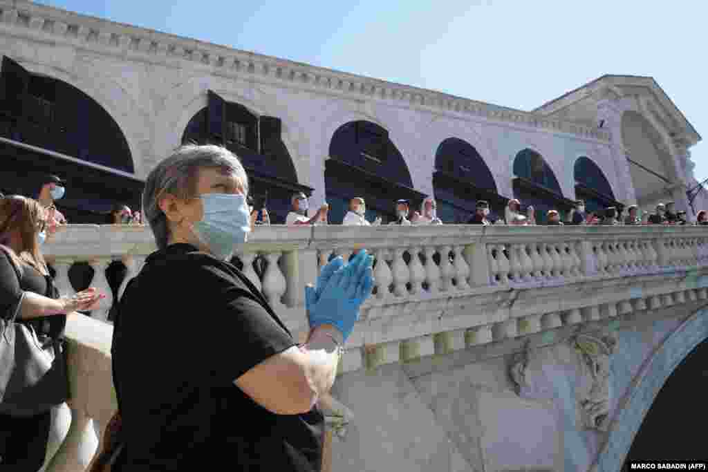 Italian shopkeepers gather for a flash-mob protest on the Rialto Bridge on May 4 in Venice.
