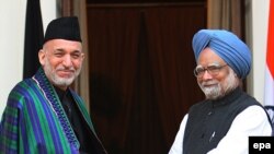 Indian Prime Minister Manmohan Singh (right, with Afghan President Hamid Karzai in New Delhi in January) will keep his job in a neighborhood engulfed in crisis and conflict.