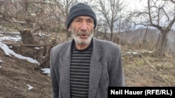 Seventy-three-year-old Zaven stands next to his home in the village of Davit Bek, in Armenia, near the border with Azerbaijan. "They fired a shell that landed right here," he says of his property coming under Azerbaijani artillery fire.