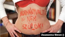 A photo from Zsuzsanna Simon's series, in which women wrote "I will not give birth until there's a change in government" -- or something similar -- on their bodies.
