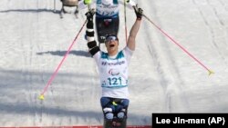 Oksana Masters of the United States celebrates as she crosses the finish line to win the gold in the women's 1.1-kilometer cross-country sprint skiing in Pyeongchang on March 14.
