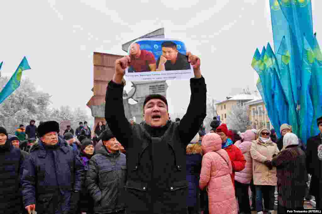 A man in Almaty holds a photo of two ethnic Kazakhs from China facing deportation back to China where many fear they may be sent to &quot;re-education camps&quot;.&nbsp;