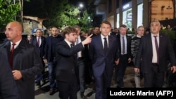France's President Emmanuel Macron and Ambassador to Armenia Olivier Decottignies walk on a street on the eve of the European Political Community summit in Yerevan on May 3, 2026.