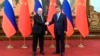 Russian Prime Minister Mikhail Mishustin (left) poses with Chinese President Xi Jinping prior to talks in Beijing on May 24.